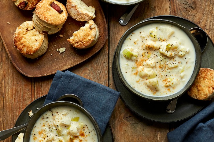 Bowls filled with creamy cauliflower chowder and sprinkled with red cayenne pepper