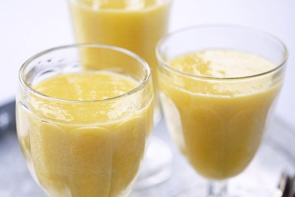 Three glasses of mango smoothie