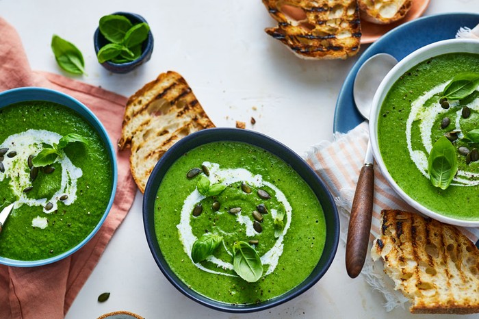 Three bowls of green soup