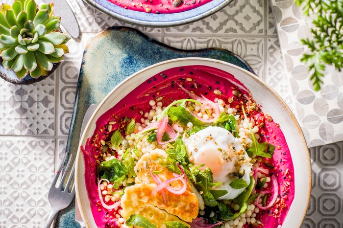 Halloumi, eggi and salad bowl on a bed of pureed beetroot borani yogurt