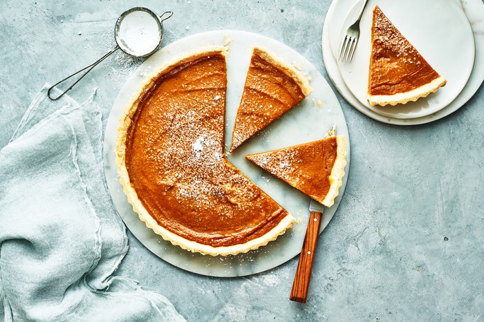 Pumpkin pie on a grey marble kitchen top