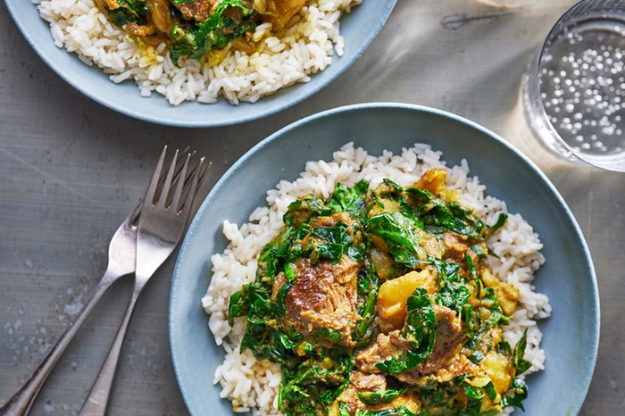 Two plates of beef curry on rice