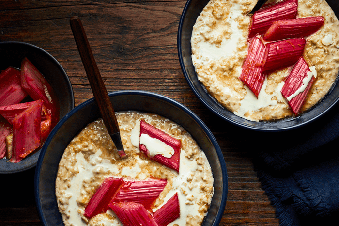 Two bowls of malted milk porridge with pieces of rhubarb on top